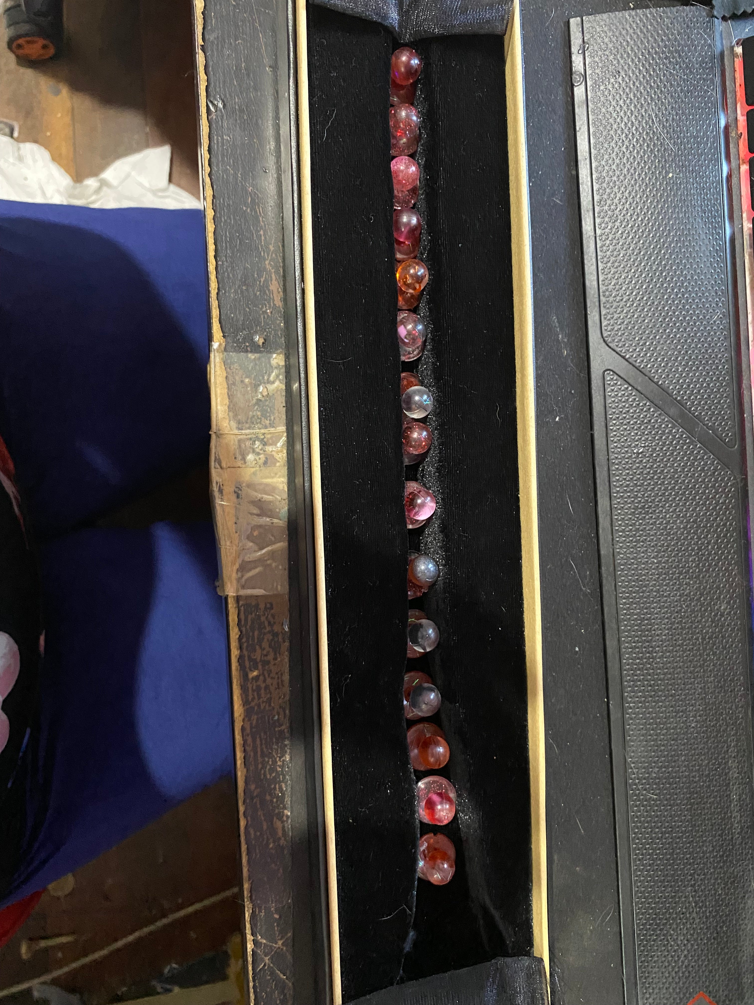 Unique chef buttons displayed in a black velvet-lined box, featuring various colors and patterns.
