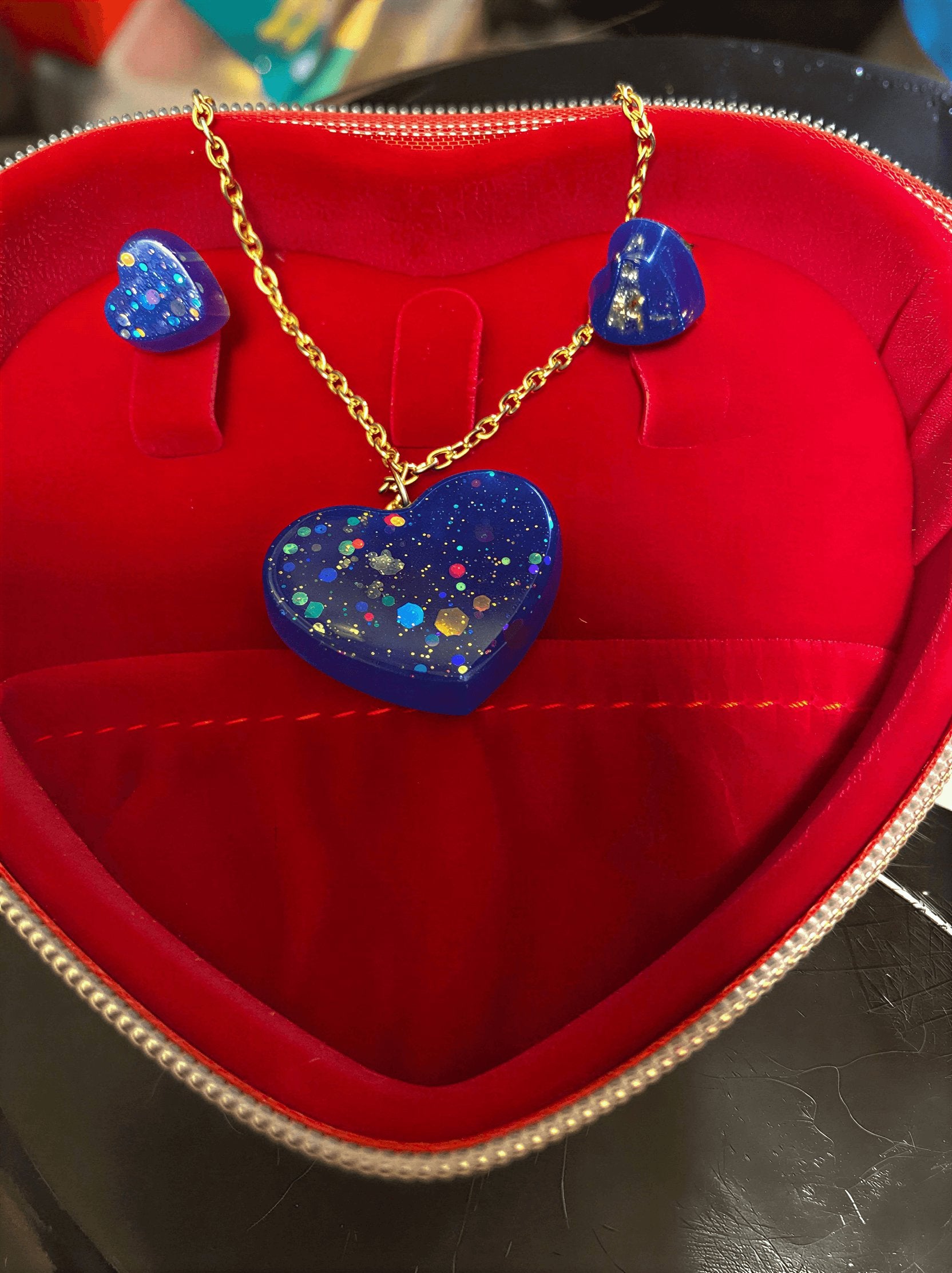 love heart pendant and earring set featuring a blue heart pendant and matching earrings in a red jewelry box.