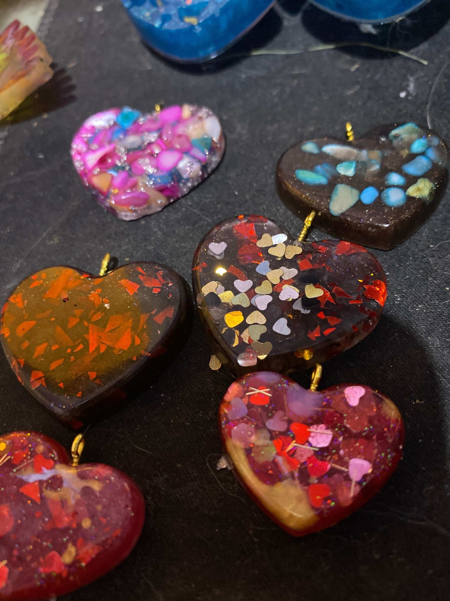 Colorful love heart pendant and earring set featuring various heart shapes with glitter and resin details.