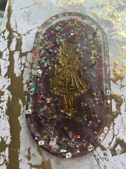Alice in Wonderland trinket tray with a gold figure, purple resin, and colorful glitter accents.