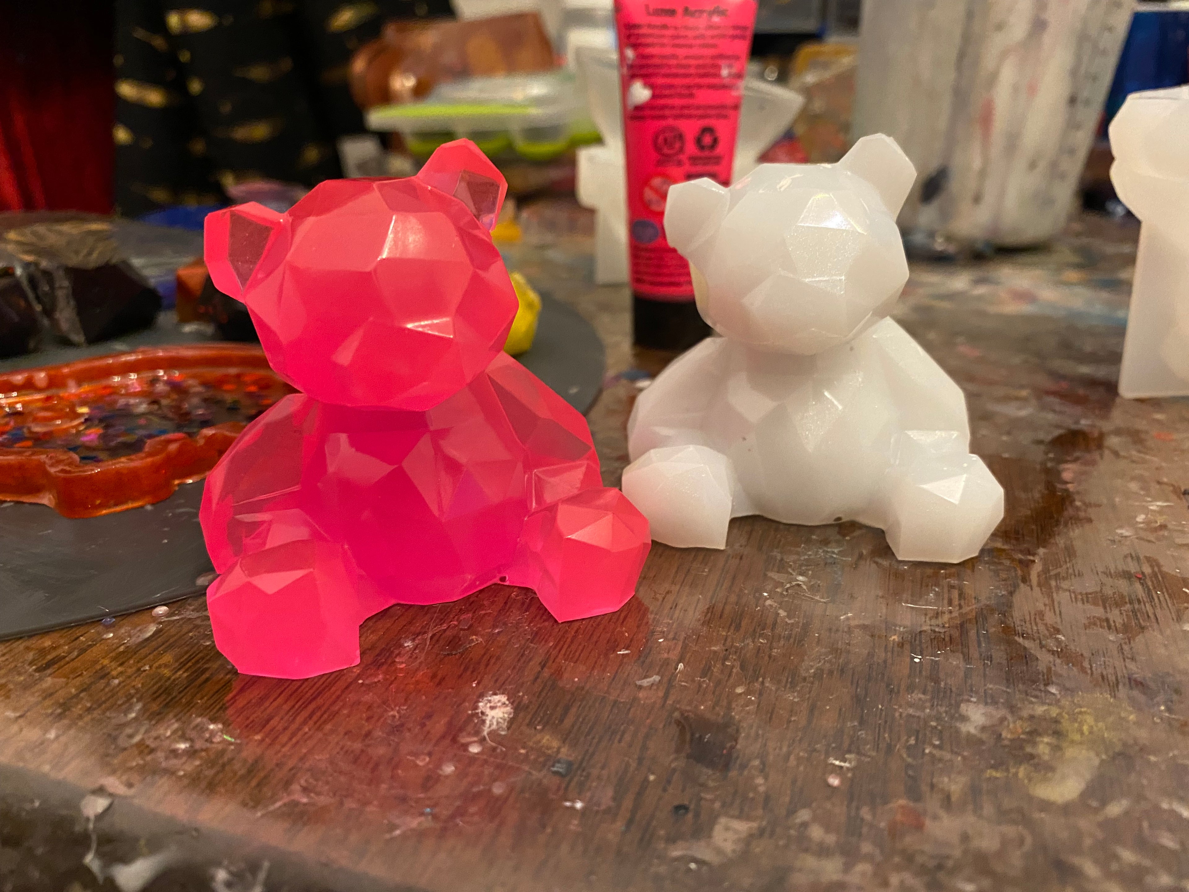 Personalised Valentines bear in pink and white, featuring a geometric design on a cluttered artist's workspace.