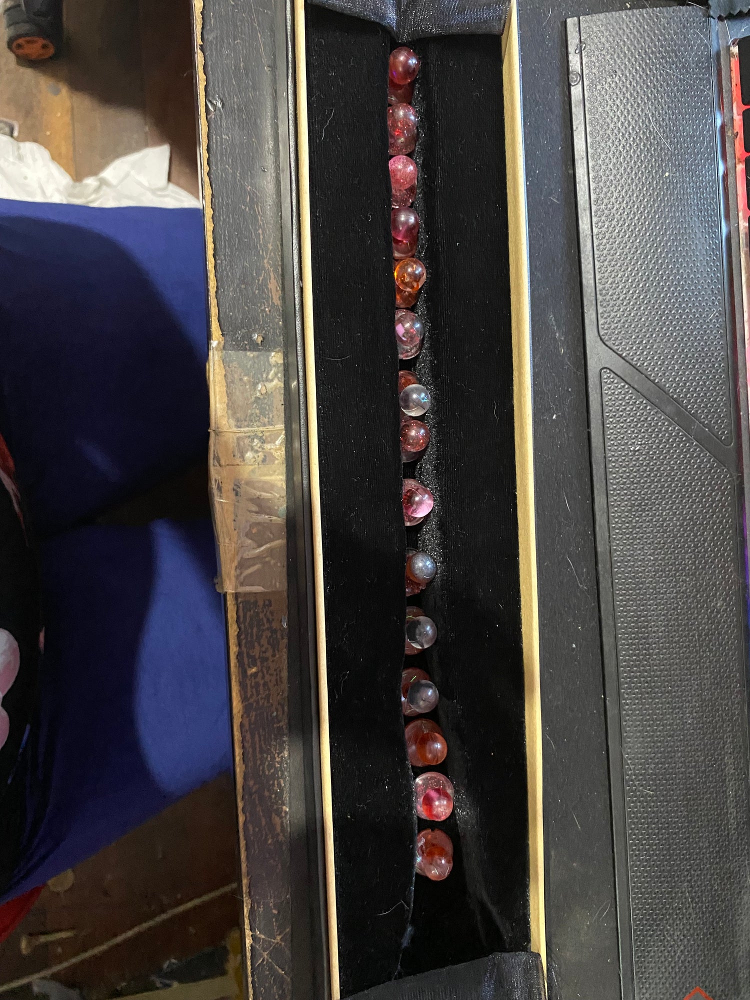 Unique chef buttons displayed in a black velvet-lined box, featuring various colors and patterns.