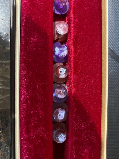 Unique chef buttons displayed in a velvet-lined box, featuring various colors and intricate designs.