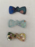 Personalised Pet ID tags by Piggymac Creations, bow-shaped multicolour speckled tags for pets.