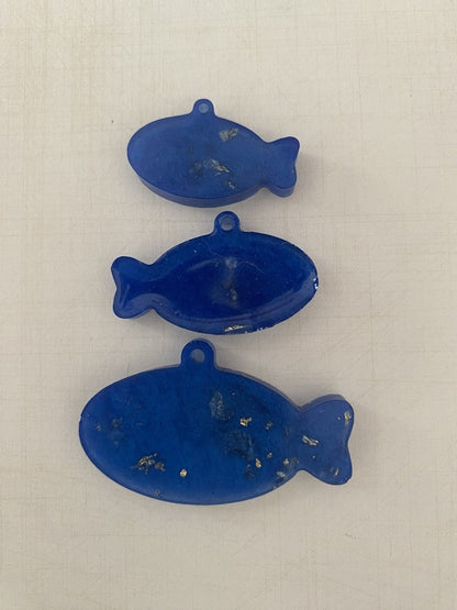 Personalised Pet ID tags by Piggymac Creations, blue fish-shaped tags with hanging holes and speckled finish