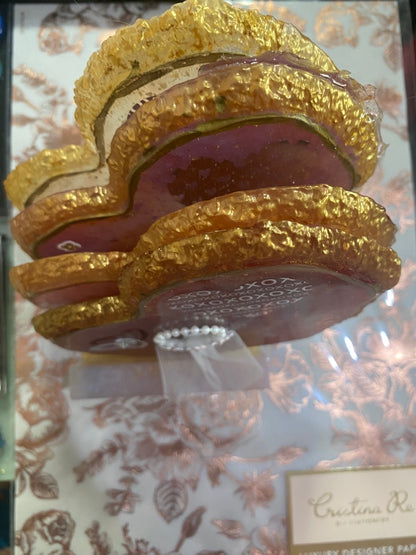 Wedding coaster set featuring pink and gold coasters with a floral design and decorative pearl accents.
