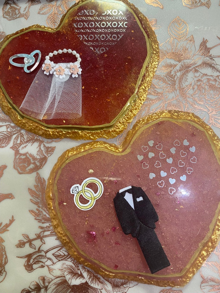 Heart-shaped wedding coasters featuring a bridal bouquet and tuxedo designs with decorative hearts.
