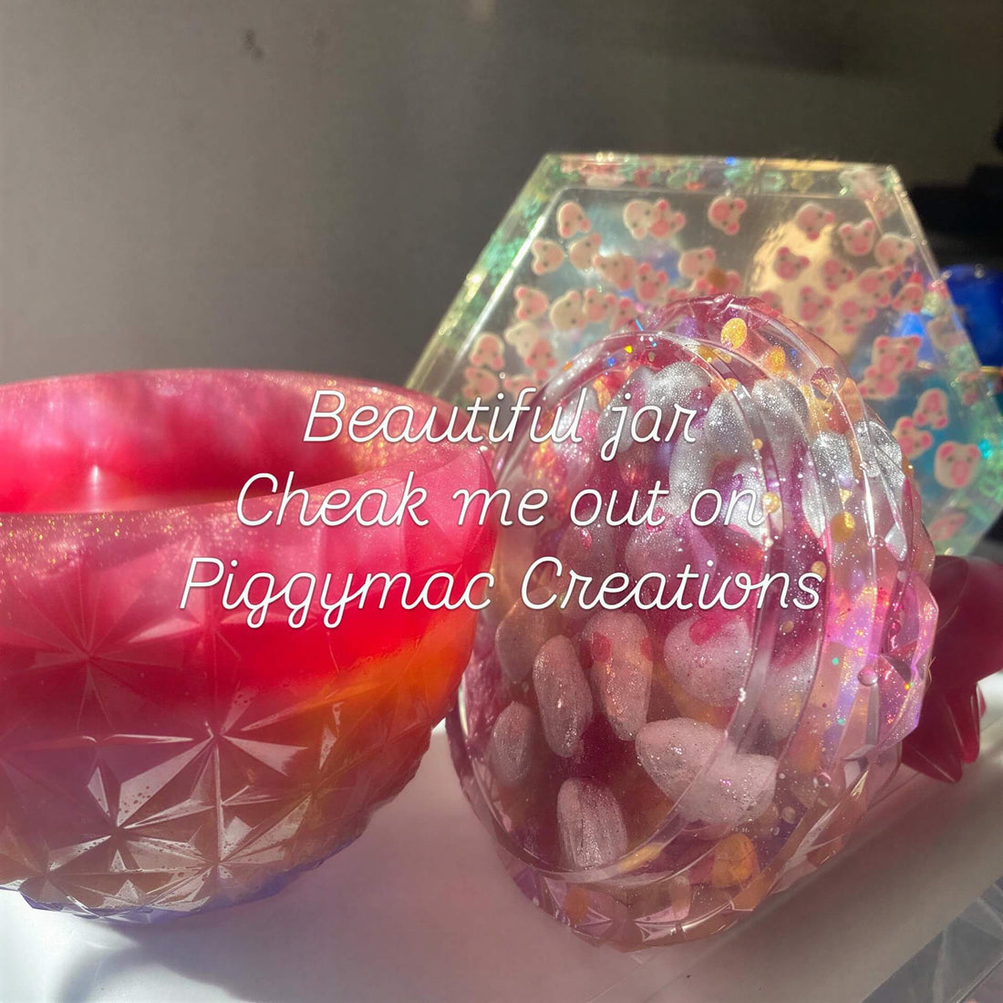 Large pink and purple resin jar with a textured surface, featuring colorful stones inside, displayed on a light background.