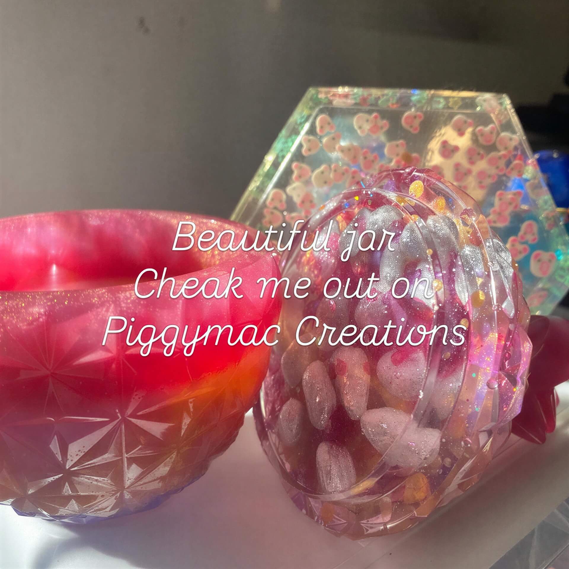 Large pink and purple resin jar with a textured surface, featuring colorful stones inside, displayed on a light background.